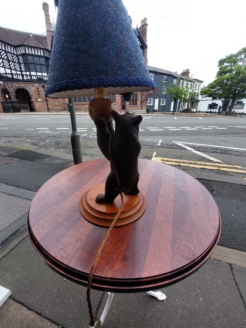 An early twentieth-century carved lindenwood Black Forest bear table lamp topped with a blue tartan fabric lampshade. View VI