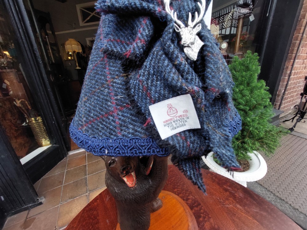 An early twentieth-century carved lindenwood Black Forest bear table lamp topped with a blue tartan fabric lampshade. View VII