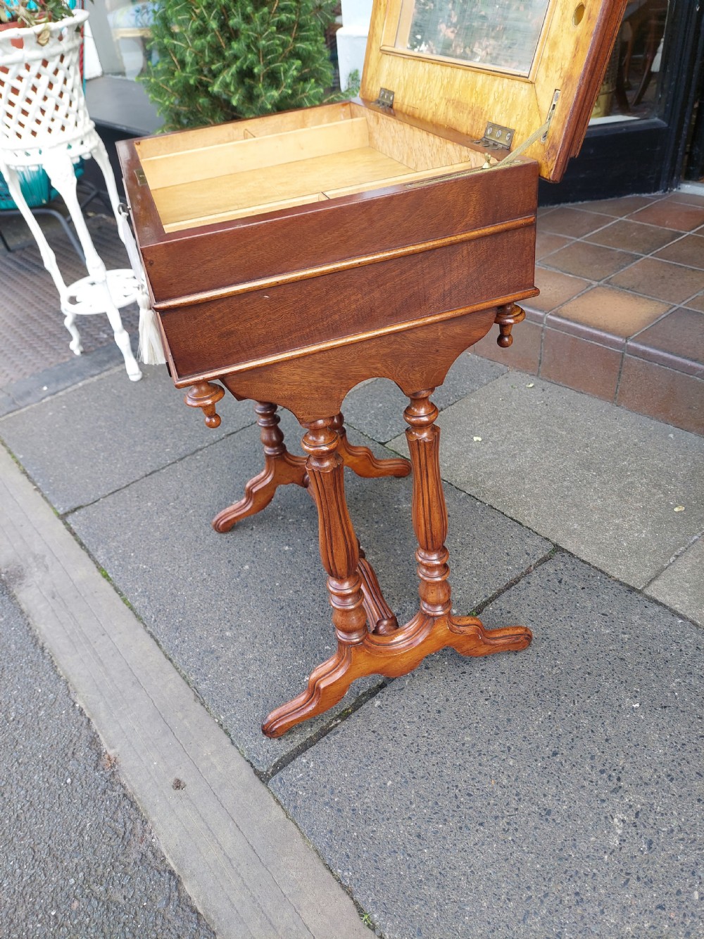 A late 19th-century mahogany sewing work table featuring a veneered rectangular top, turned support legs, a stretcher base, and a drop well. View VI