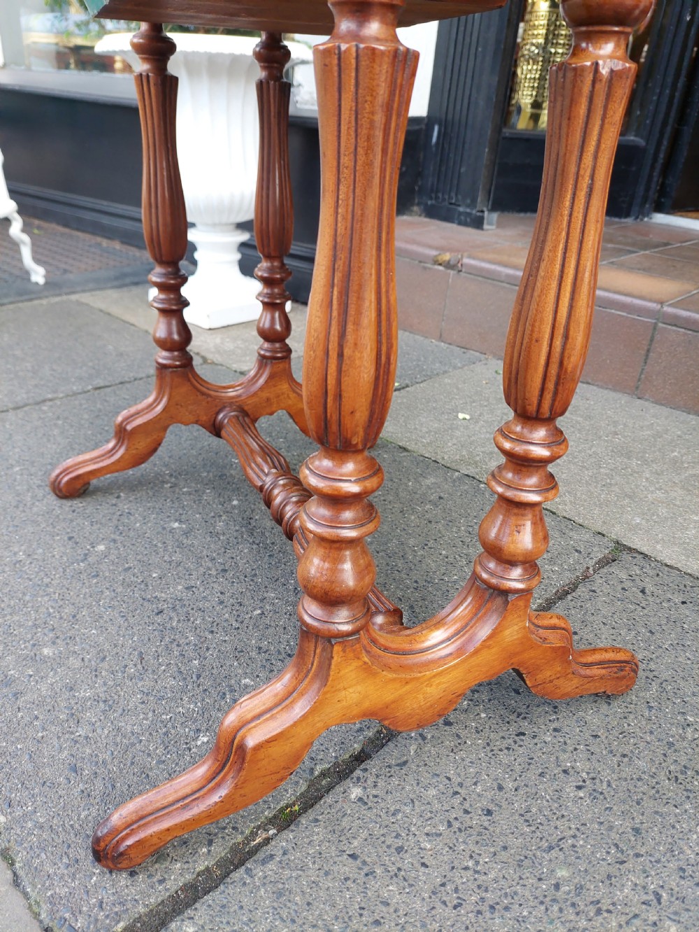A late 19th-century mahogany sewing work table featuring a veneered rectangular top, turned support legs, a stretcher base, and a drop well. View VII