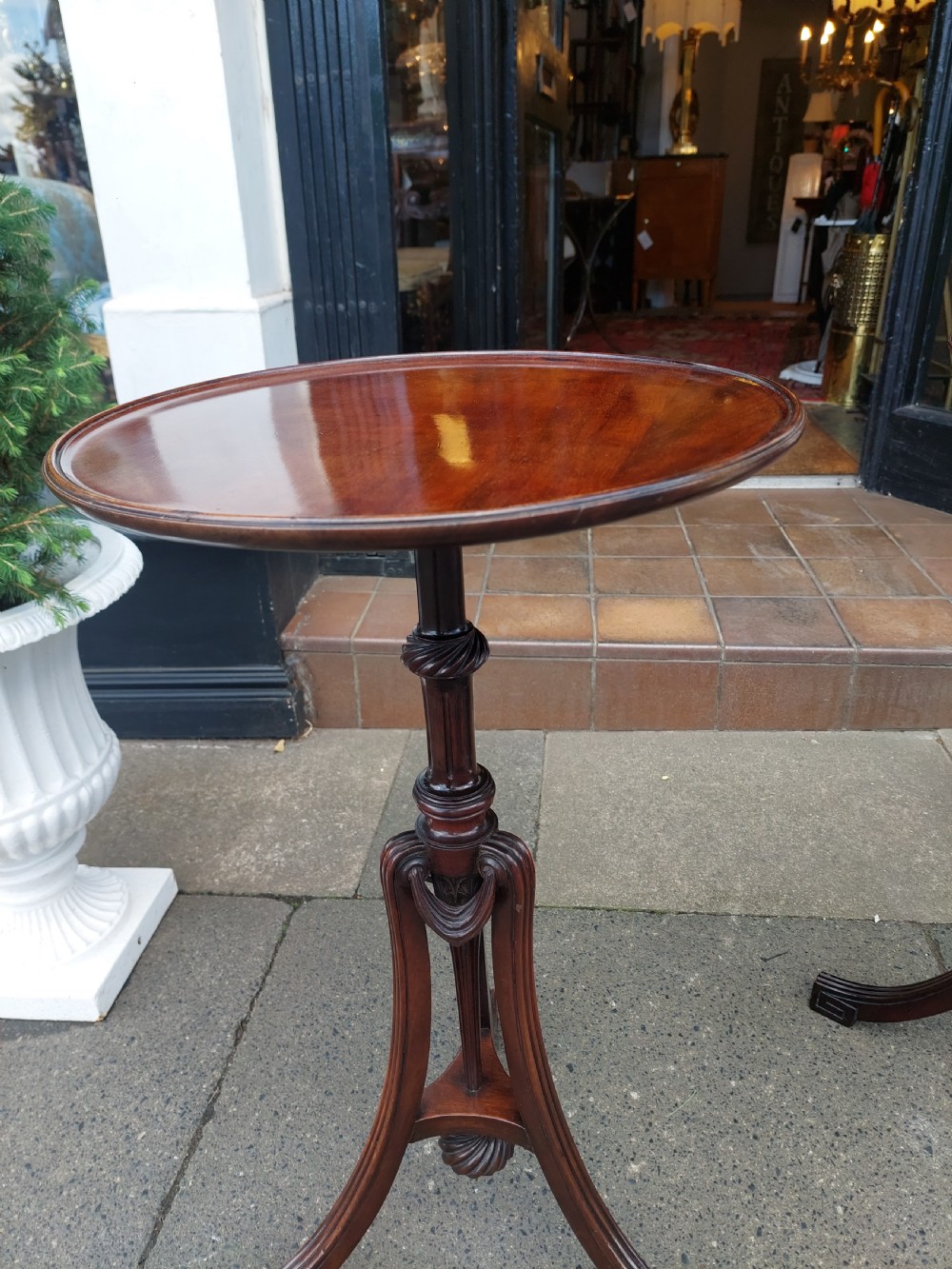 A pair of late Victorian mahogany occasional tables with circular tops, reeded columns, and carved tripod bases. View III