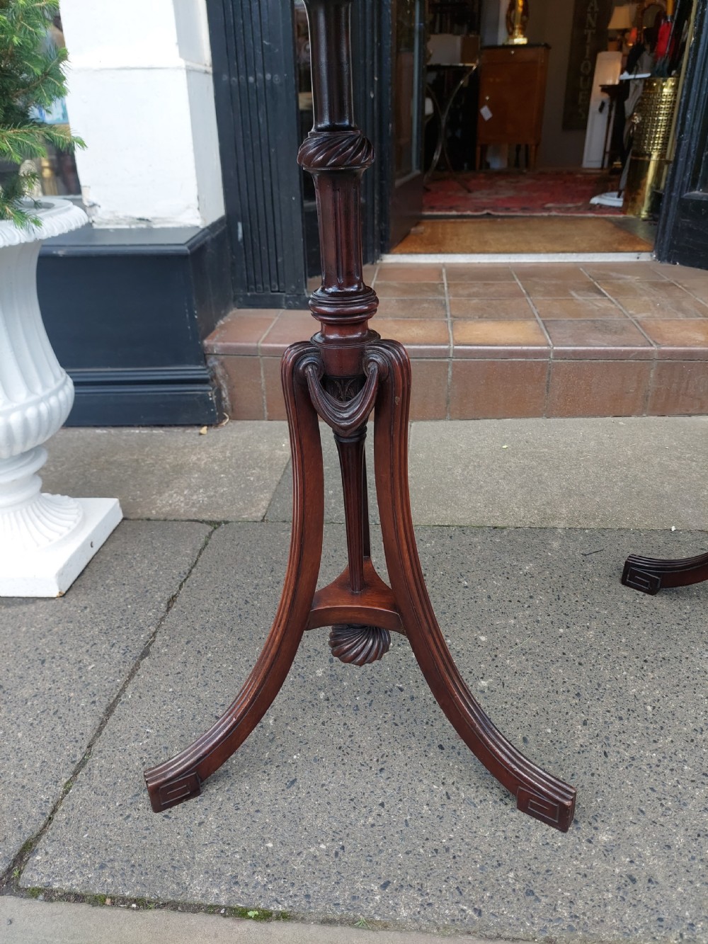 A pair of late Victorian mahogany occasional tables with circular tops, reeded columns, and carved tripod bases. View IV