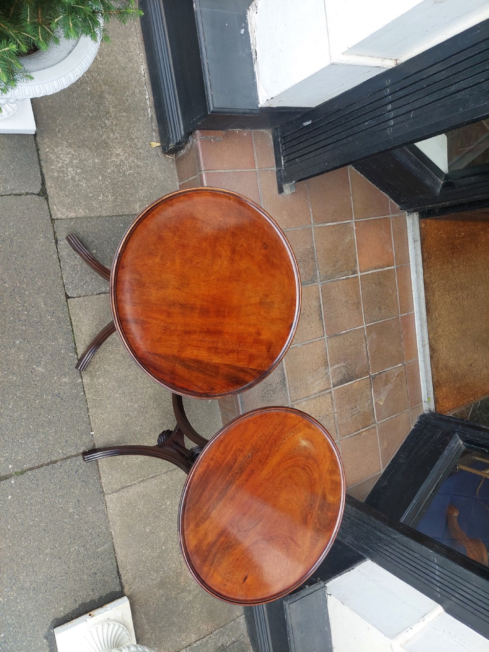 A pair of late Victorian mahogany occasional tables with circular tops, reeded columns, and carved tripod bases. View IX