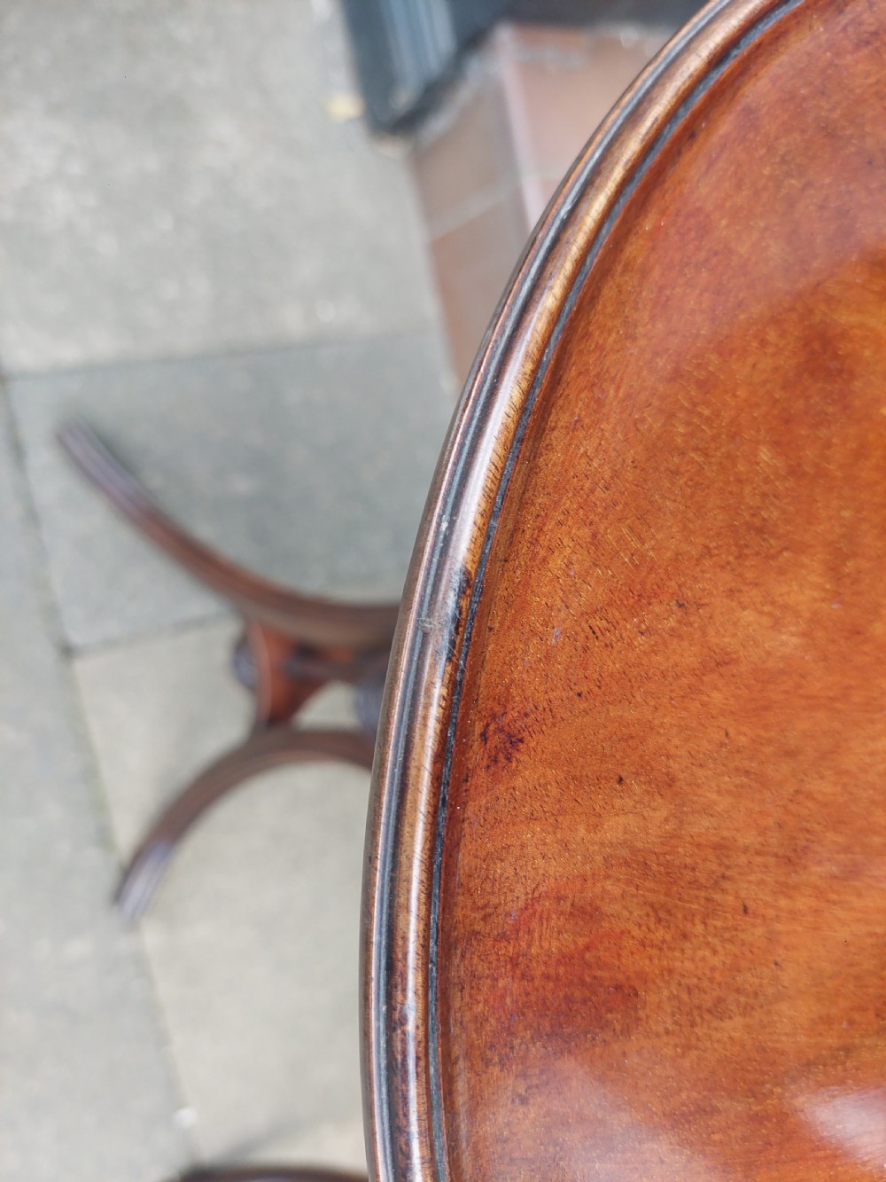 A pair of late Victorian mahogany occasional tables with circular tops, reeded columns, and carved tripod bases. View X