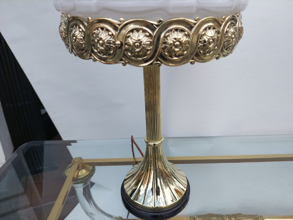 A late 19th-century Victorian brass table lamp featuring a fluted column, patterned brass rim gallery, and moulded white glass shade. View V