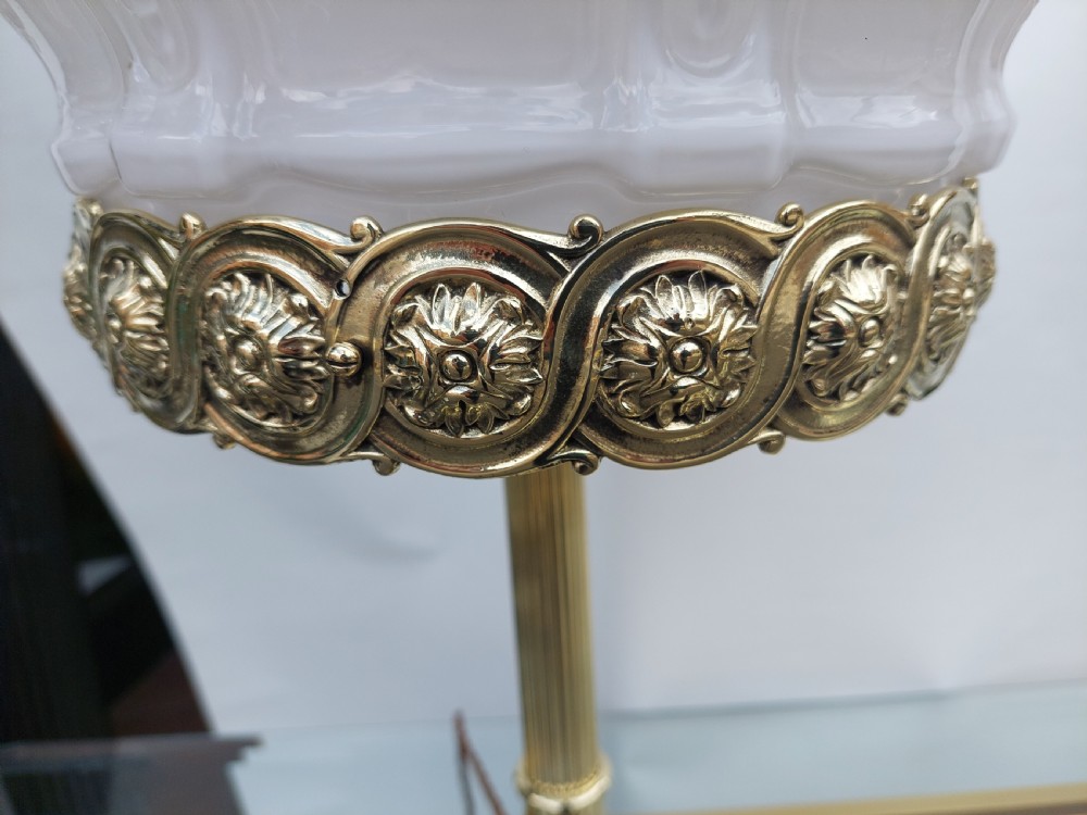 A late 19th-century Victorian brass table lamp featuring a fluted column, patterned brass rim gallery, and moulded white glass shade. View VII