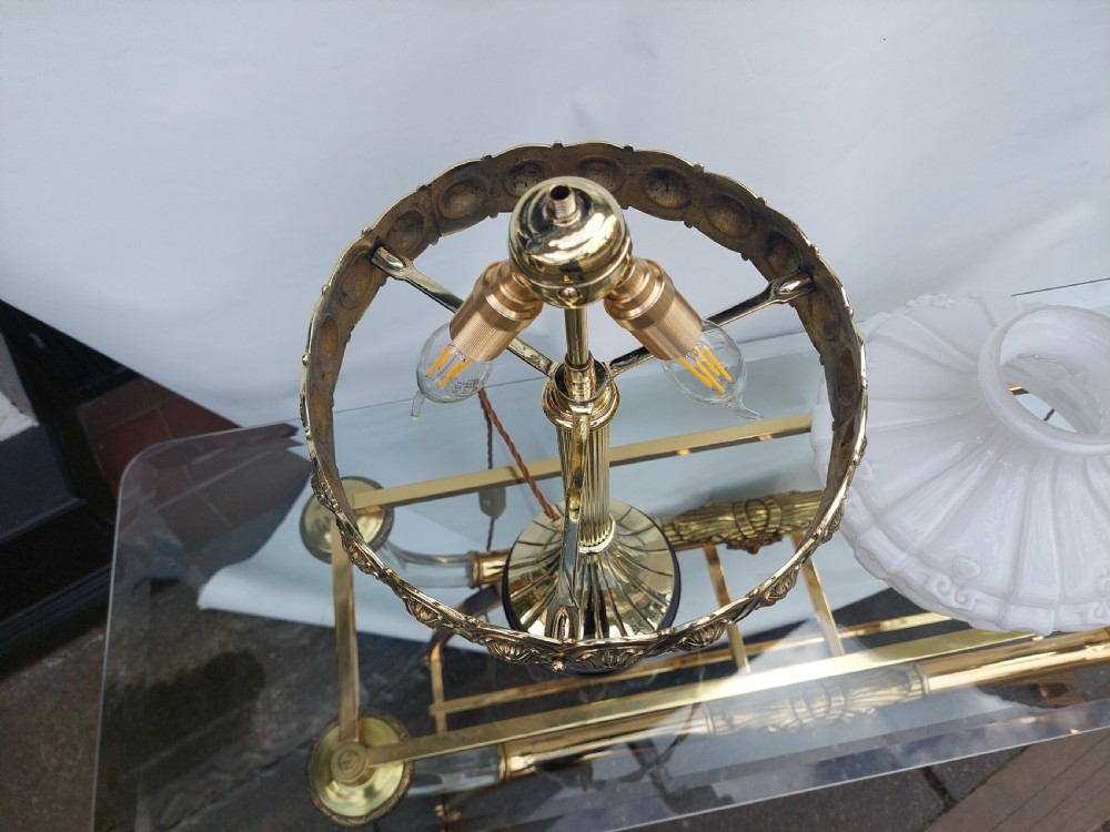 A late 19th-century Victorian brass table lamp featuring a fluted column, patterned brass rim gallery, and moulded white glass shade. View IX