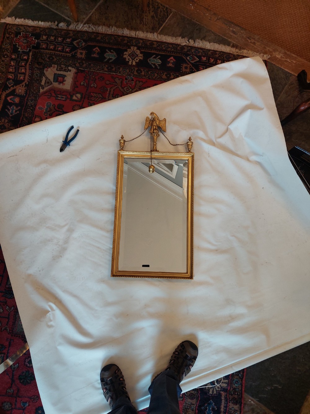 A tall rectangular George III giltwood pier mirror featuring an eagle surmounting a central crest with delicate hanging chains and flanking corner finials. View II