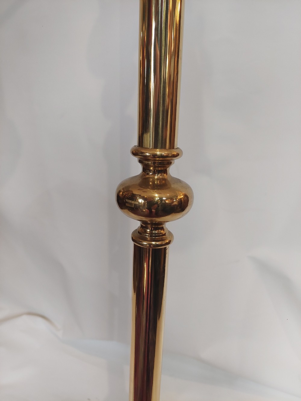 An Art Nouveau brass standard lamp with a slender central column, three curving arms holding frilled pink glass shades, and a tripod base. View IX