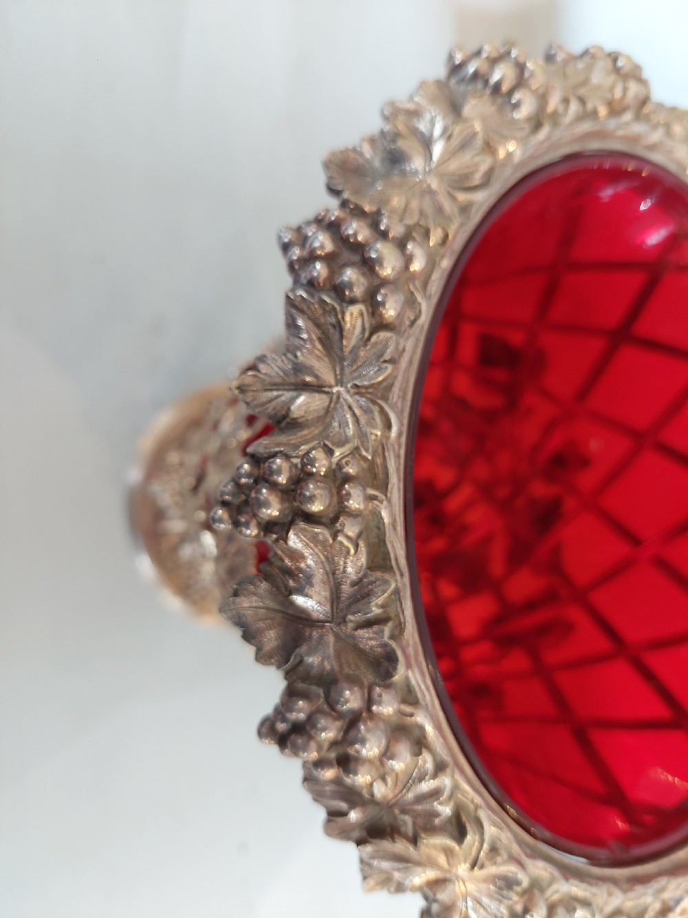 A late nineteenth-century cranberry glass wine cooler encased in an ornate silver-plated lattice frame with sculpted grapevine and leaf motifs. View III