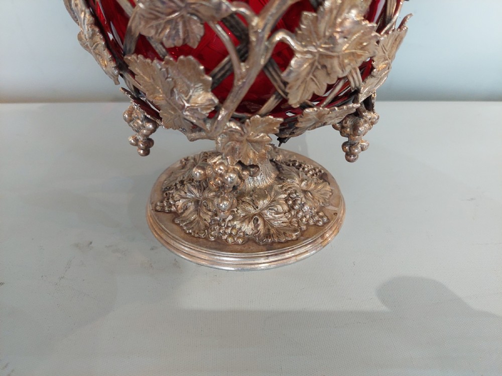 A late nineteenth-century cranberry glass wine cooler encased in an ornate silver-plated lattice frame with sculpted grapevine and leaf motifs. View IV