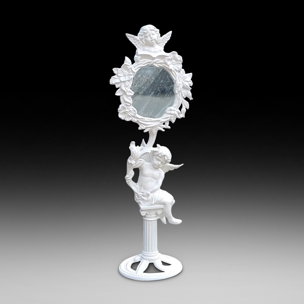 A white-painted cast iron tabletop mirror featuring cherub figures, floral garlands, and a central column pedestal.