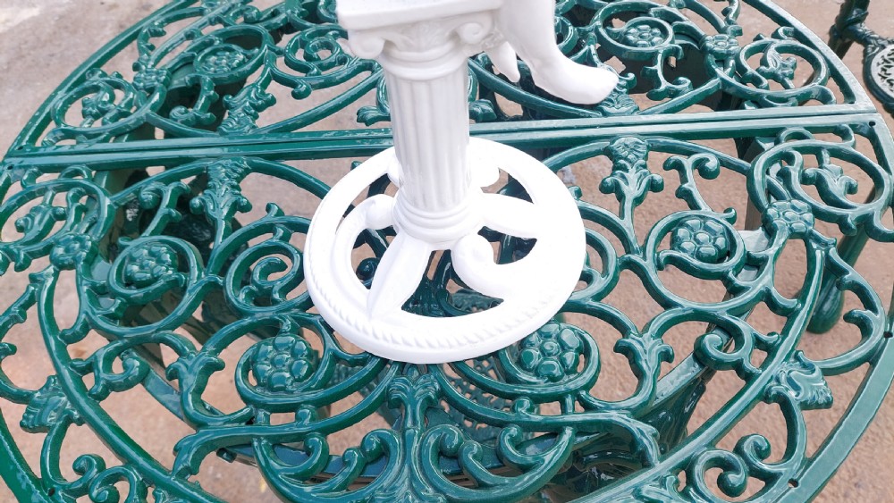 A white-painted cast iron tabletop mirror featuring cherub figures, floral garlands, and a central column pedestal. View V