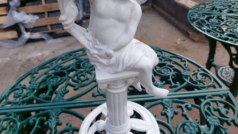 A white-painted cast iron tabletop mirror featuring cherub figures, floral garlands, and a central column pedestal. View VI