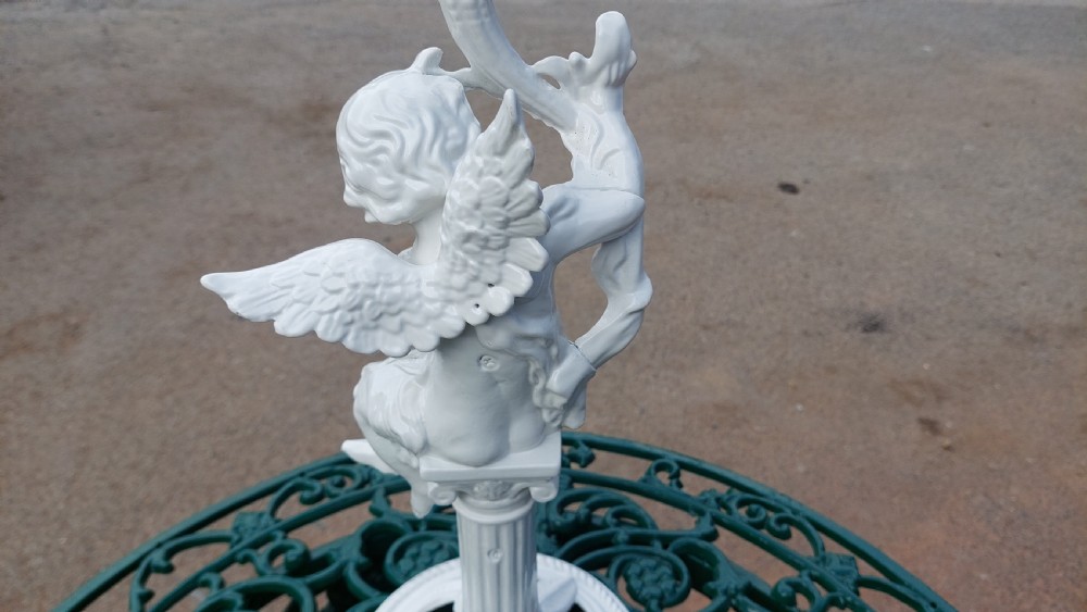 A white-painted cast iron tabletop mirror featuring cherub figures, floral garlands, and a central column pedestal. View VII
