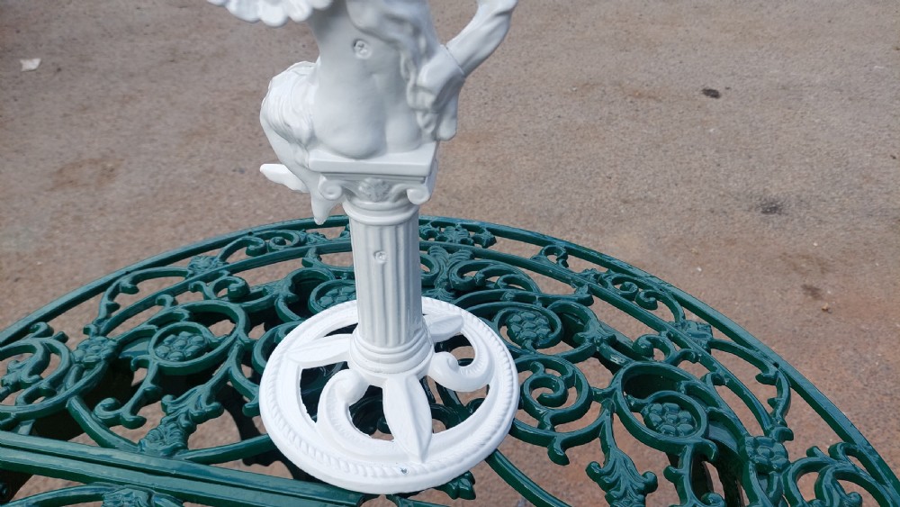 A white-painted cast iron tabletop mirror featuring cherub figures, floral garlands, and a central column pedestal. View VIII