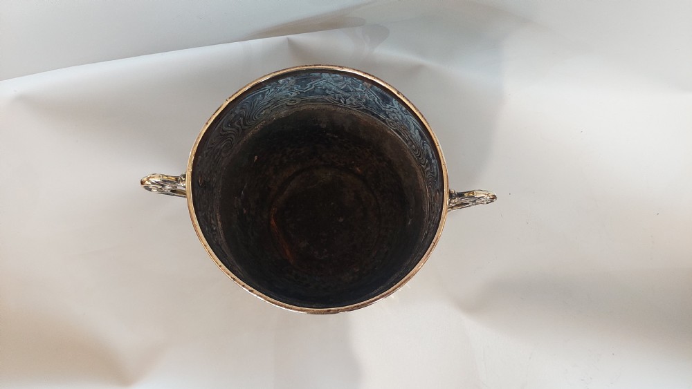 A late nineteenth-century French brass two-handled trophy vase with an embossed foliate frieze and a hammered base. View III