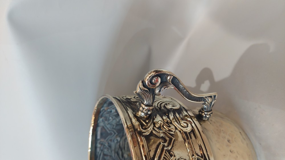 A late nineteenth-century French brass two-handled trophy vase with an embossed foliate frieze and a hammered base. View IV