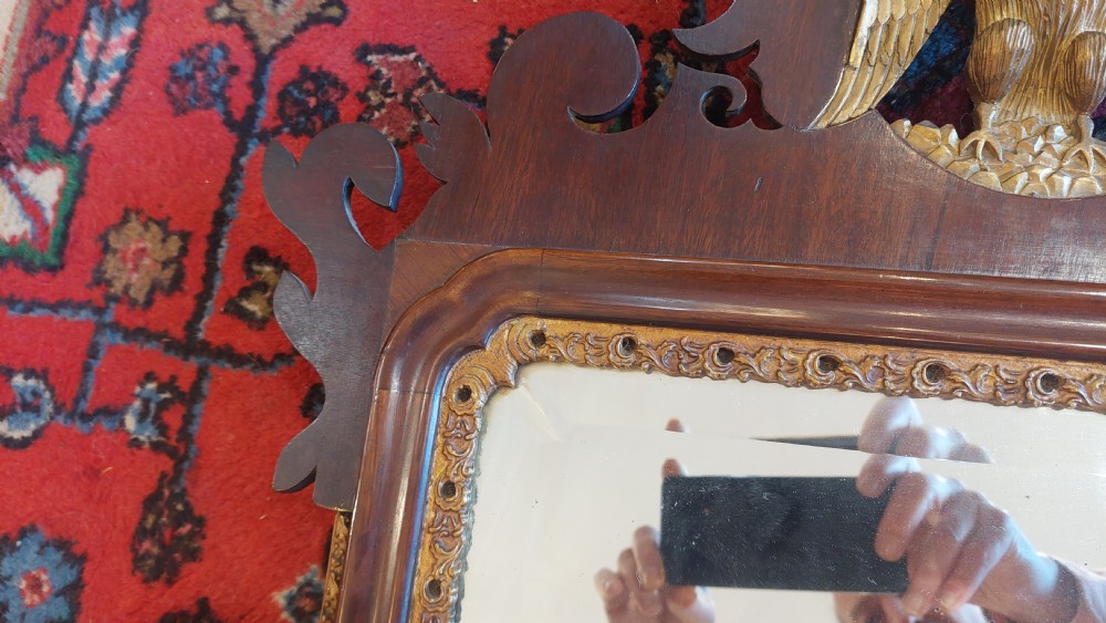 A late 19th-century George II style wall mirror framed in walnut with scrollwork edges, an oval marquetry motif at the bottom, and a giltwood eagle cresting at the top. View II