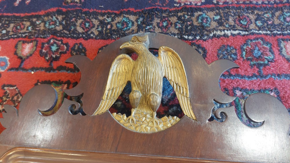 A late 19th-century George II style wall mirror framed in walnut with scrollwork edges, an oval marquetry motif at the bottom, and a giltwood eagle cresting at the top. View III