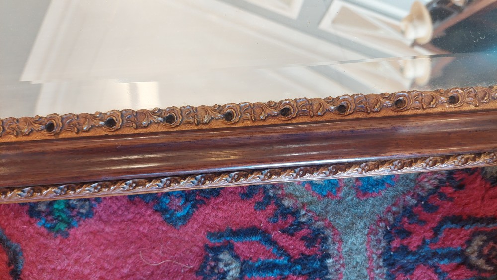 A late 19th-century George II style wall mirror framed in walnut with scrollwork edges, an oval marquetry motif at the bottom, and a giltwood eagle cresting at the top. View IV