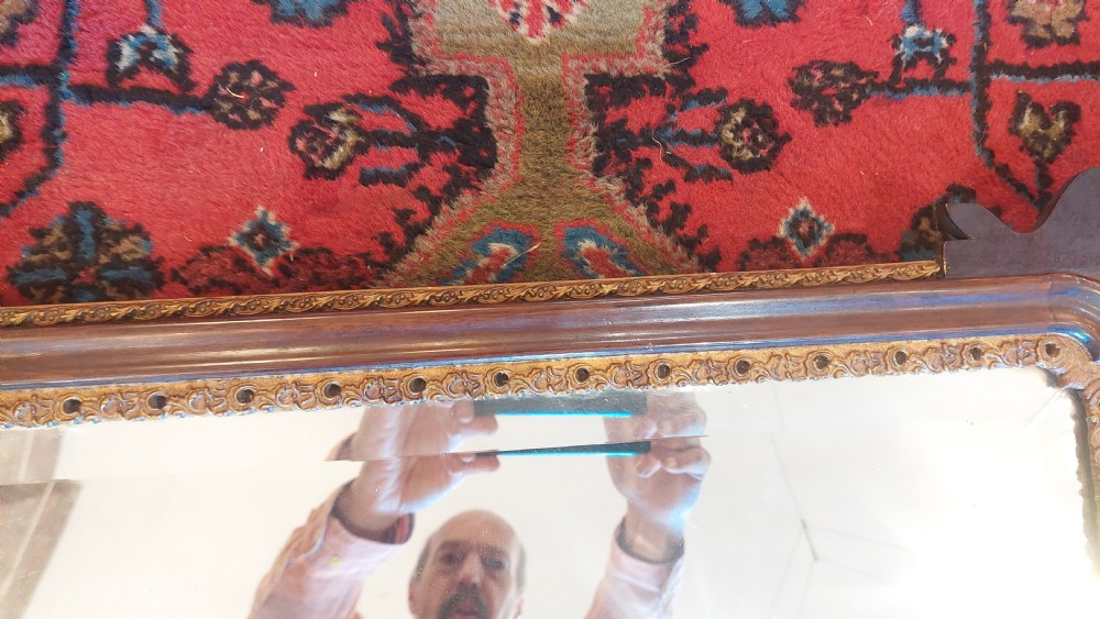 A late 19th-century George II style wall mirror framed in walnut with scrollwork edges, an oval marquetry motif at the bottom, and a giltwood eagle cresting at the top. View V