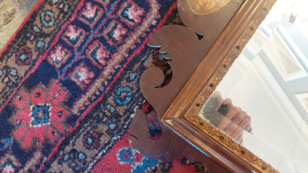 A late 19th-century George II style wall mirror framed in walnut with scrollwork edges, an oval marquetry motif at the bottom, and a giltwood eagle cresting at the top. View VII
