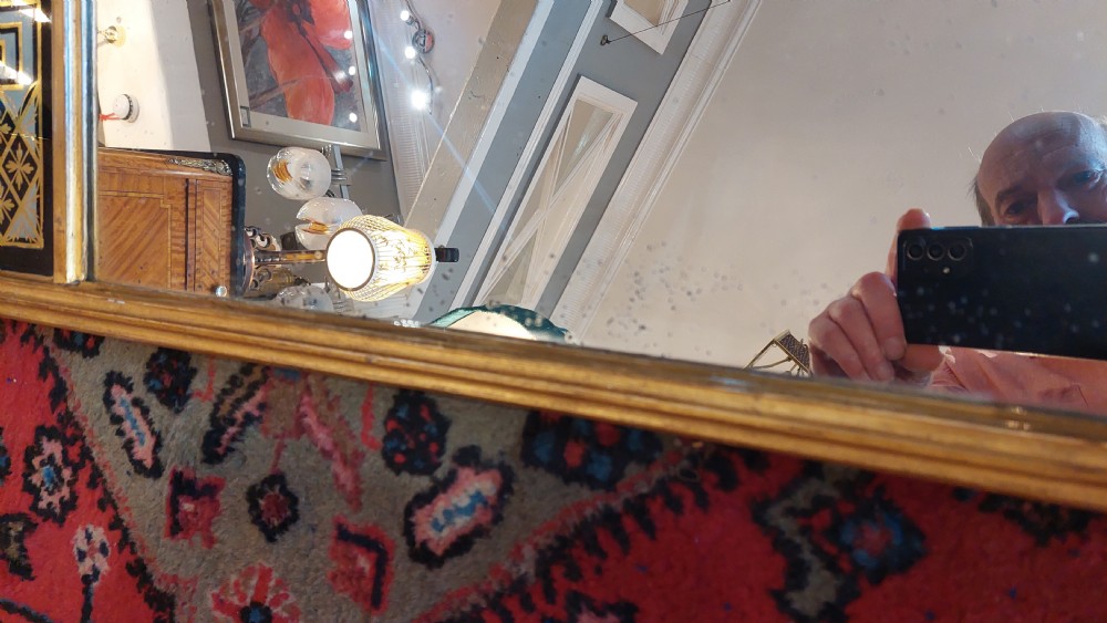 An upright rectangular Regency giltwood wall mirror featuring fluted pilasters and a frieze panel with Greek key detailing. View IV