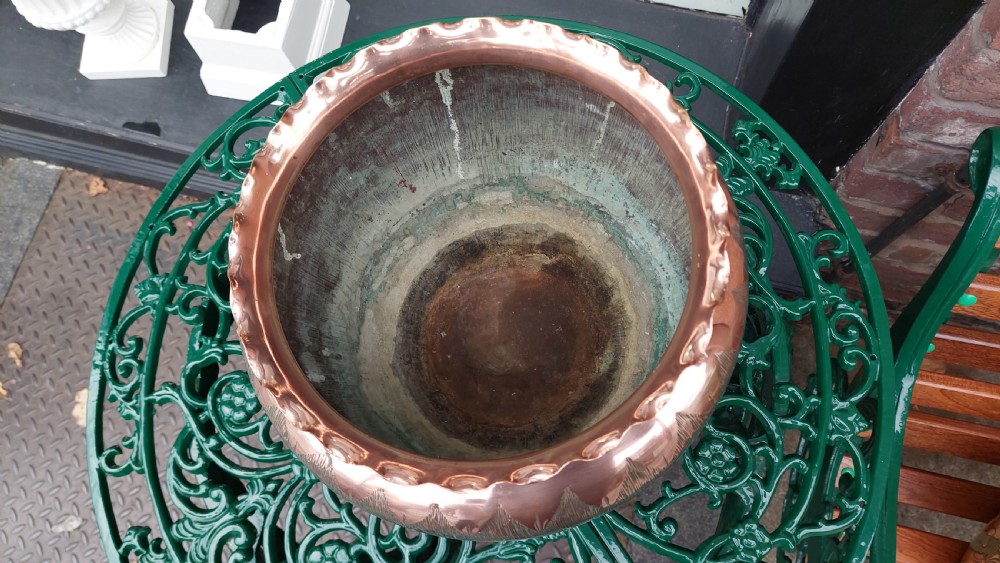 A round copper Arts and Crafts jardiniere featuring a textured hammered body and a crimped ruffled rim. View II