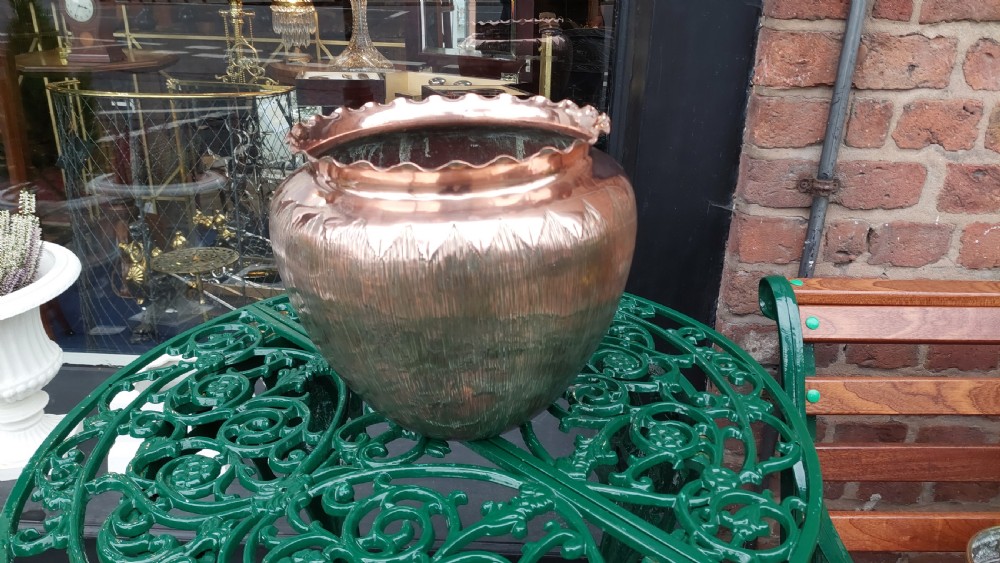 A round copper Arts and Crafts jardiniere featuring a textured hammered body and a crimped ruffled rim. View III