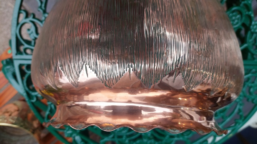 A round copper Arts and Crafts jardiniere featuring a textured hammered body and a crimped ruffled rim. View VI