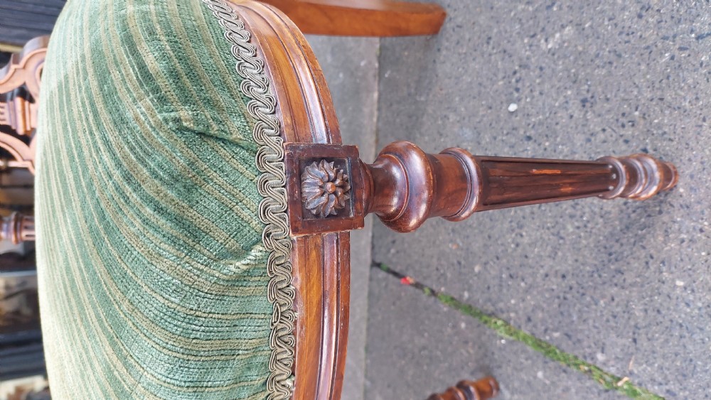A pair of Victorian mahogany occasional chairs featuring fluted front legs and padded green velvet seats and backrests. View II