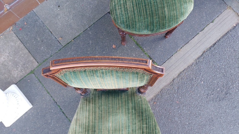 A pair of Victorian mahogany occasional chairs featuring fluted front legs and padded green velvet seats and backrests. View VIII