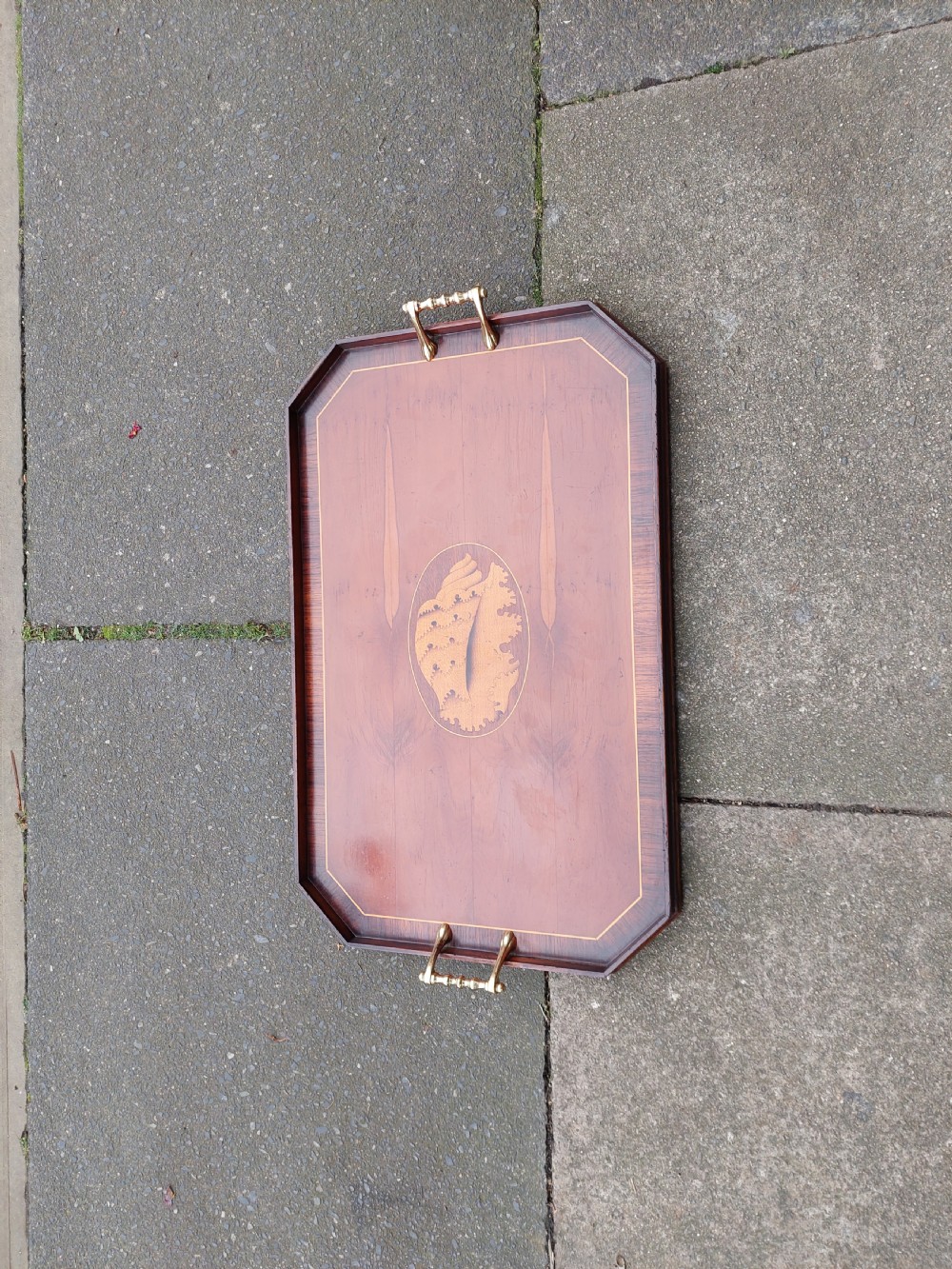 An octagonal wooden tray crafted from burr yew timber with rosewood crossbanding, featuring an oval central shell marquetry inlay and twin brass side handles. View IV