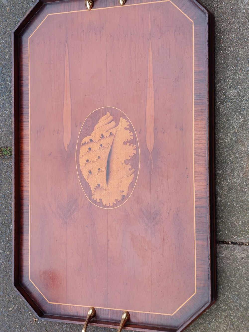 An octagonal wooden tray crafted from burr yew timber with rosewood crossbanding, featuring an oval central shell marquetry inlay and twin brass side handles. View V
