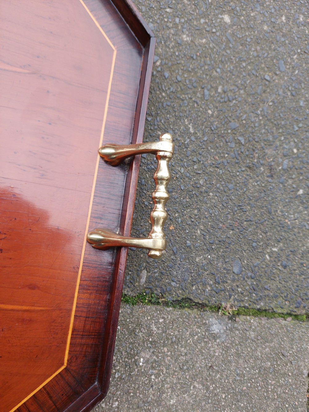 An octagonal wooden tray crafted from burr yew timber with rosewood crossbanding, featuring an oval central shell marquetry inlay and twin brass side handles. View VII