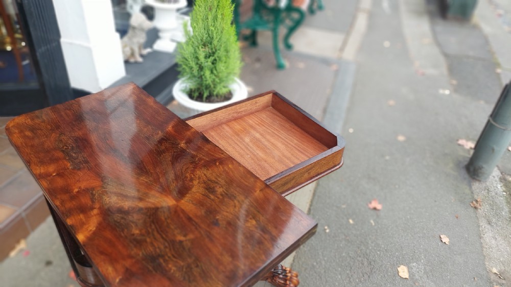 A 19th-century William IV rosewood fold-over card table supported on a central tapered pedestal and a quadruped base with carved scroll feet. View VII