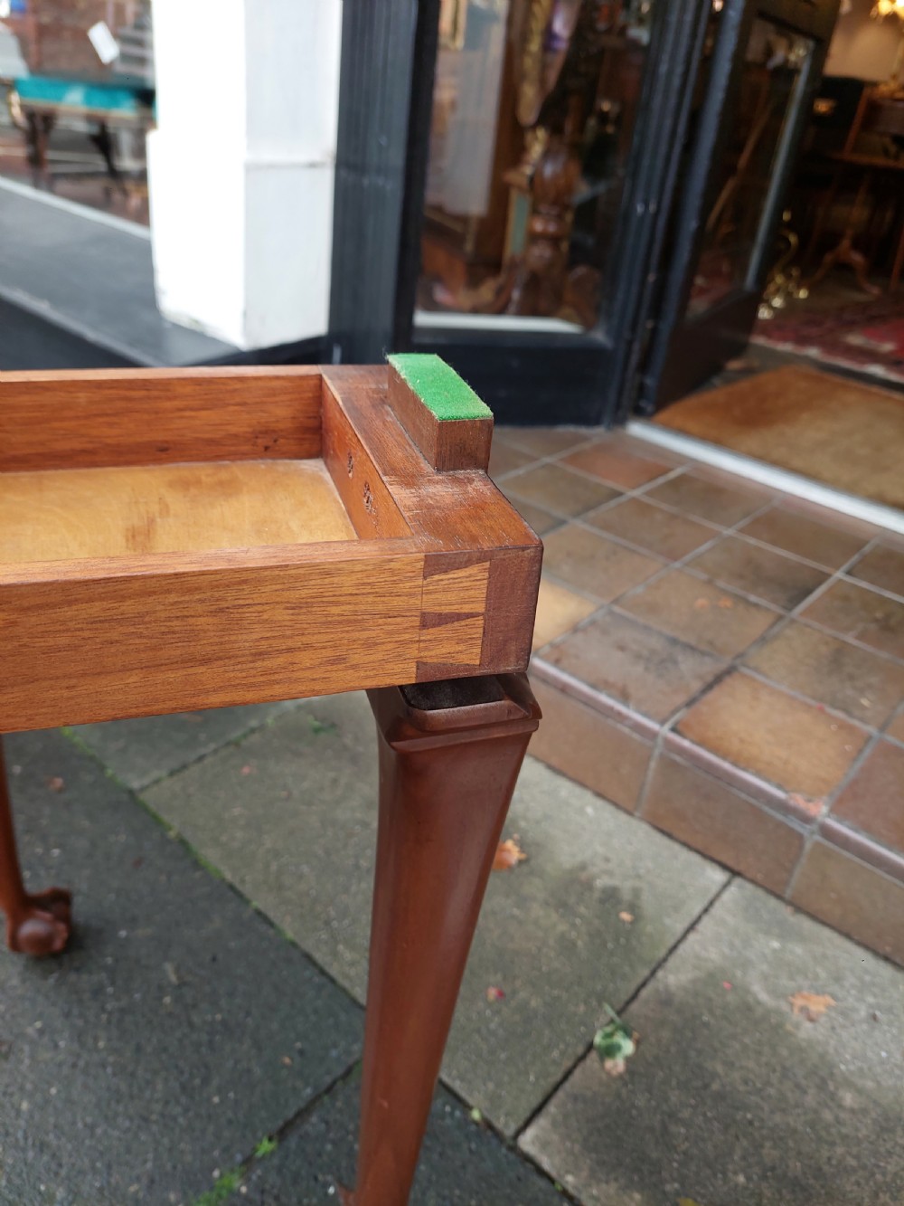 A semi-circular walnut fold-over card table with figured veneer top, carved apron, cabriole legs, and ball and claw feet. View VIII