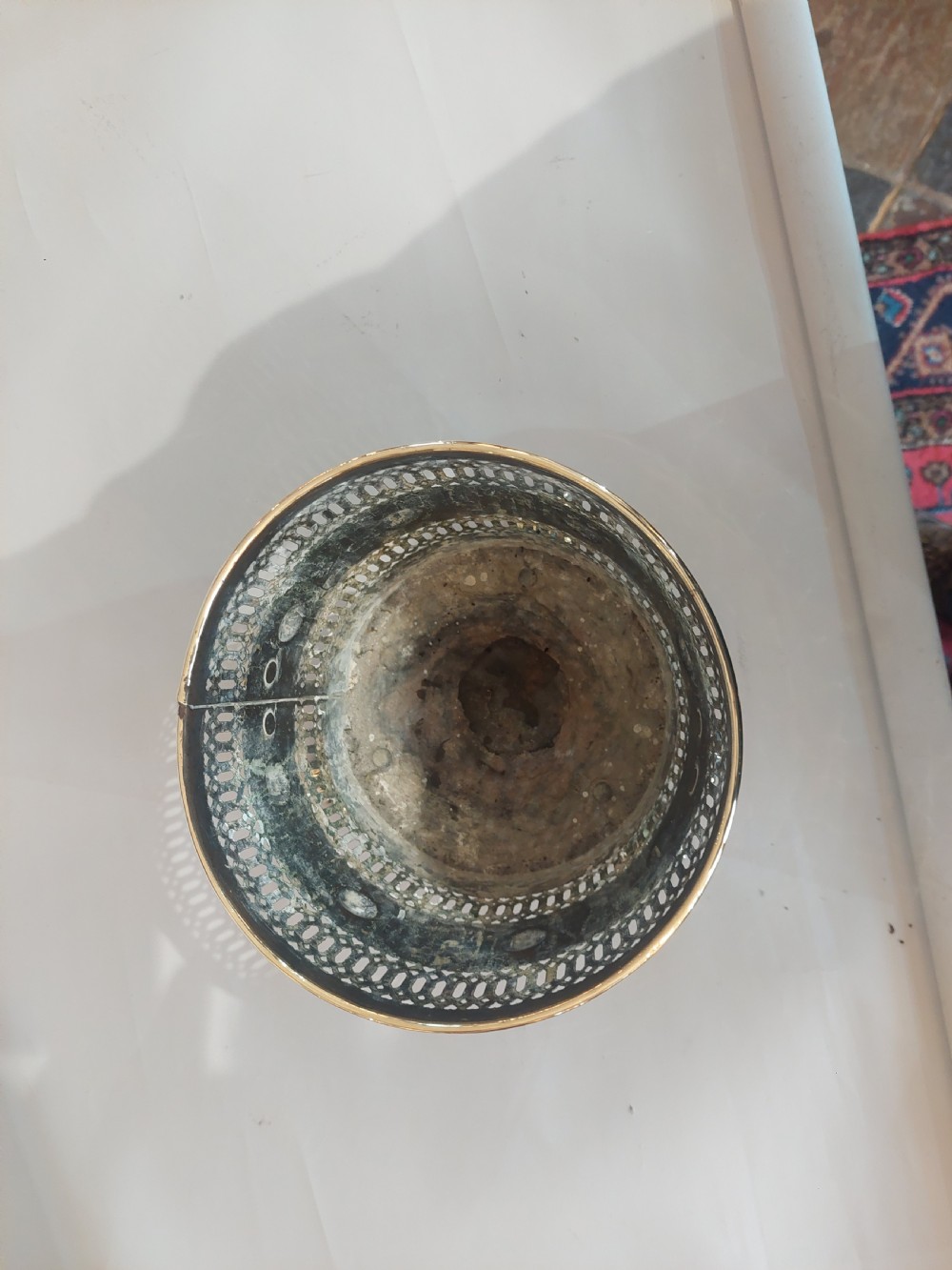 A cylindrical polished brass planter featuring pierced lattice bands, central circular bosses, side lion mask ring handles, and three claw feet. View V