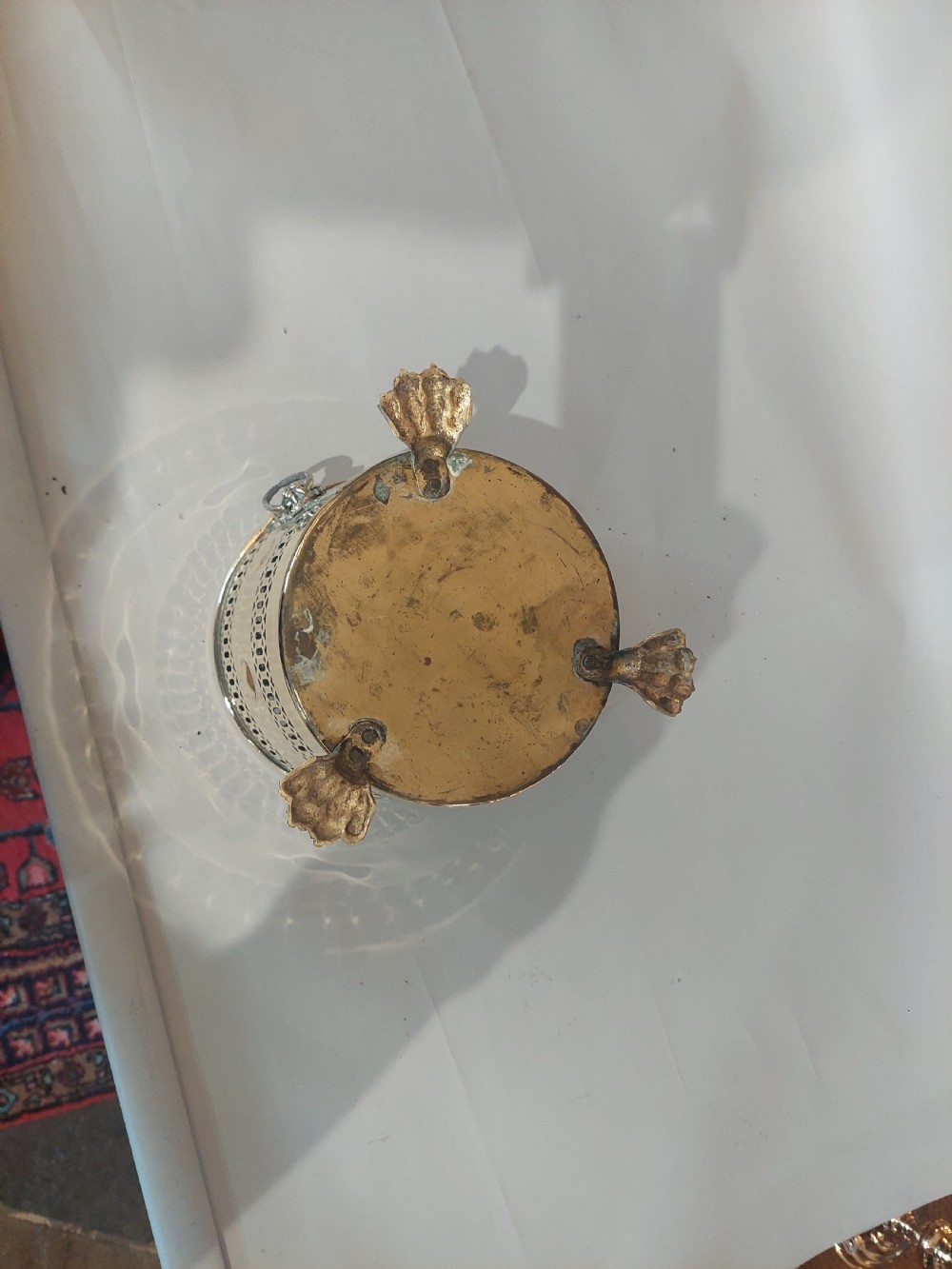 A cylindrical polished brass planter featuring pierced lattice bands, central circular bosses, side lion mask ring handles, and three claw feet. View VIII