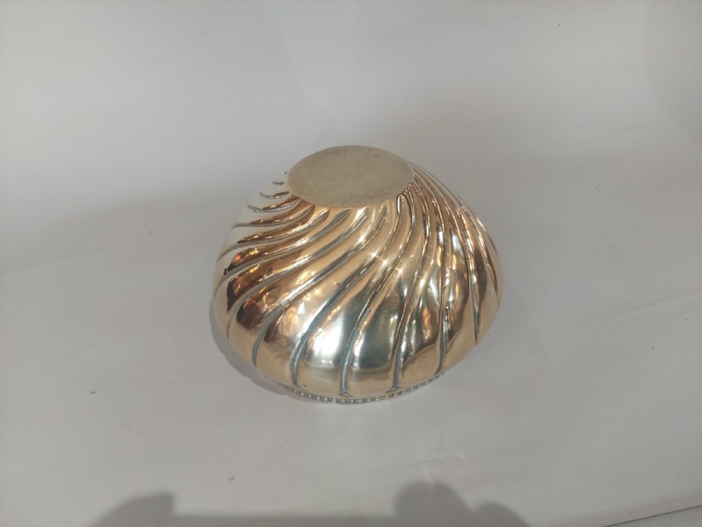 A polished brass Art Nouveau planter with swirling repousse lobed detailing and a beaded rim. View V