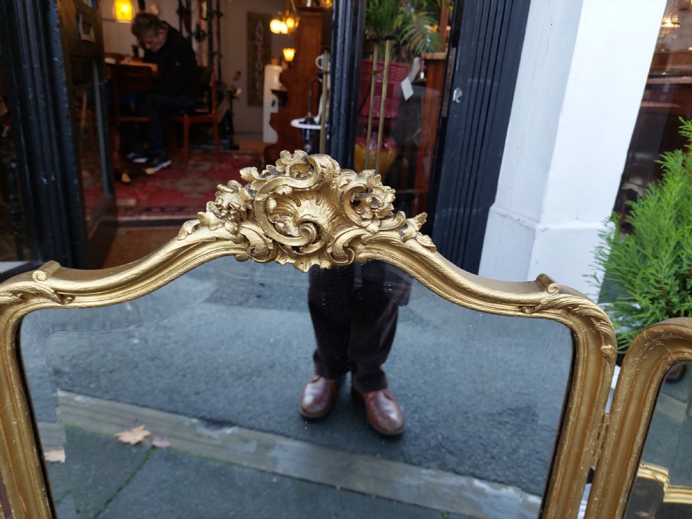 A three-panel folding triptych dressing table mirror featuring a gilded frame with Rococo carved cresting and bevelled glass. View II