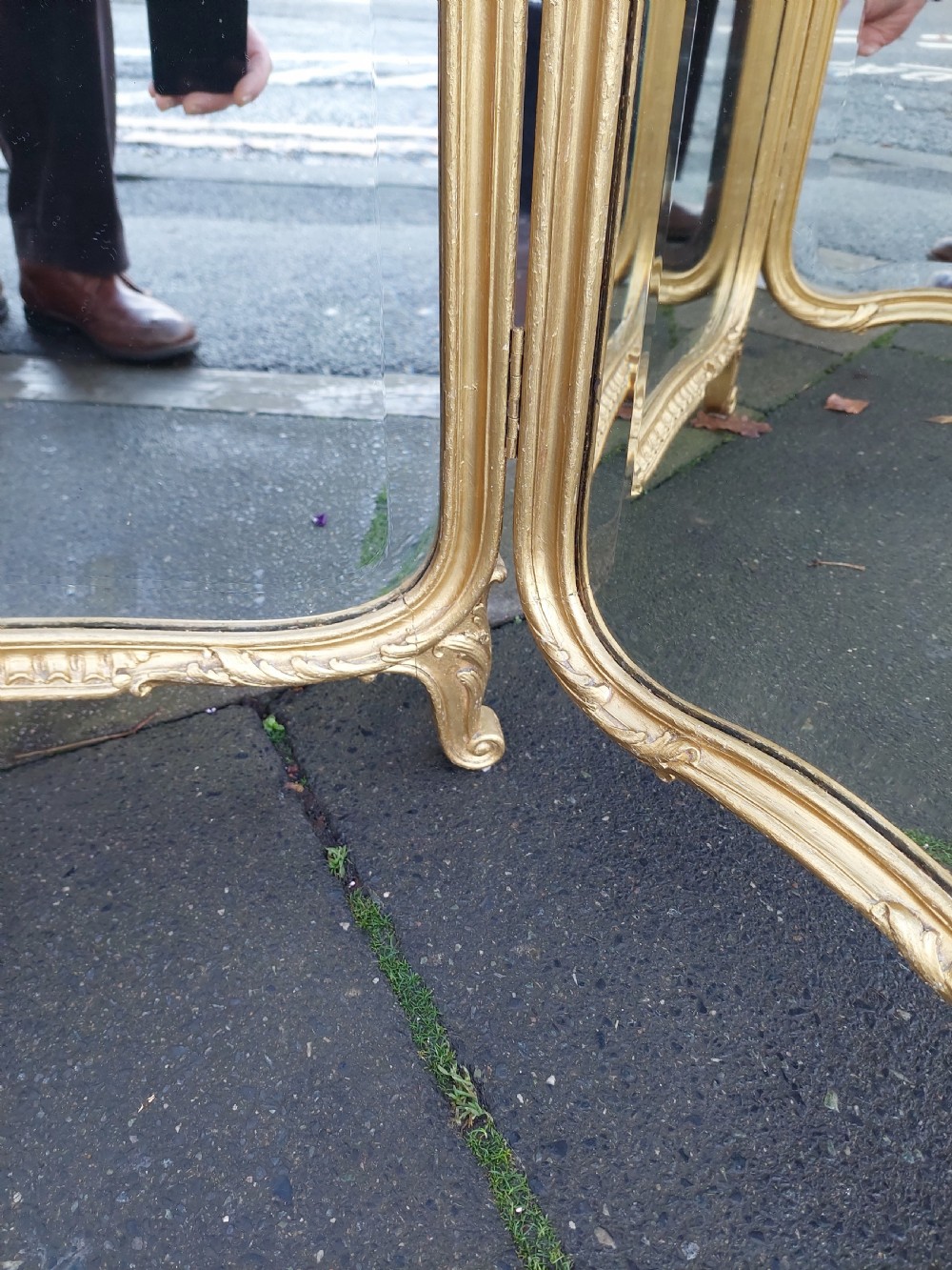 A three-panel folding triptych dressing table mirror featuring a gilded frame with Rococo carved cresting and bevelled glass. View V