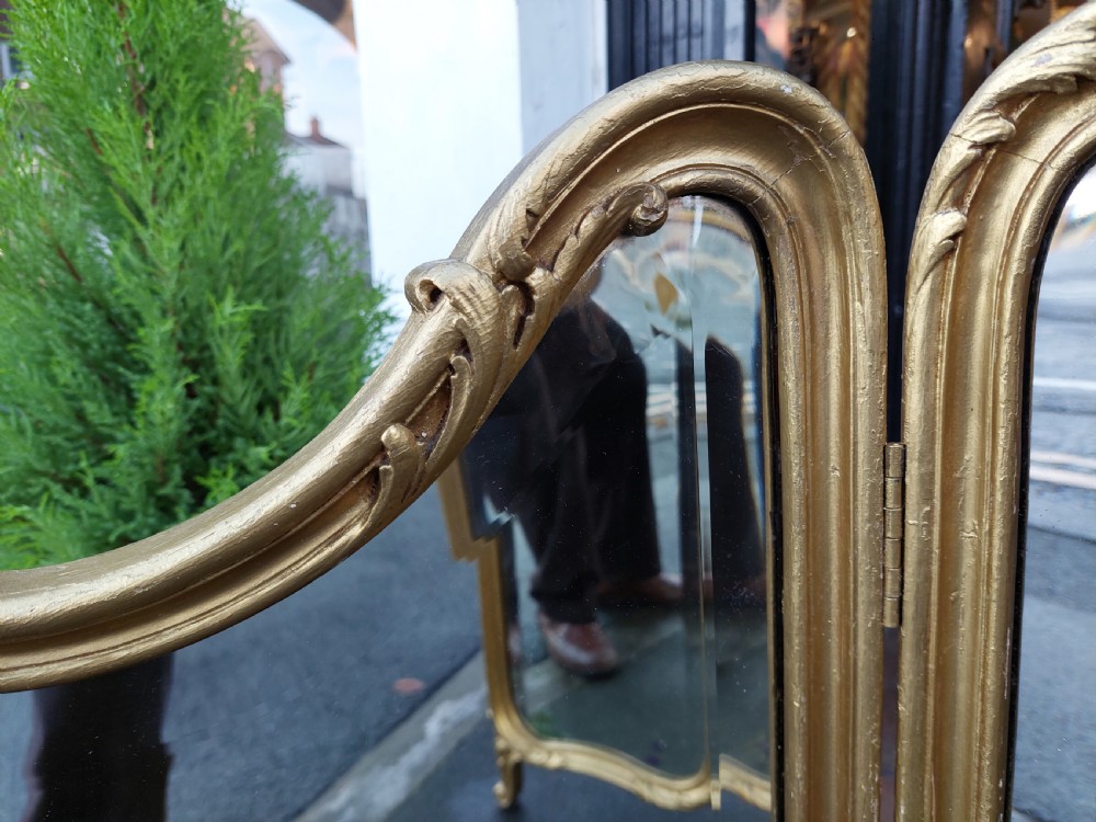 A three-panel folding triptych dressing table mirror featuring a gilded frame with Rococo carved cresting and bevelled glass. View X