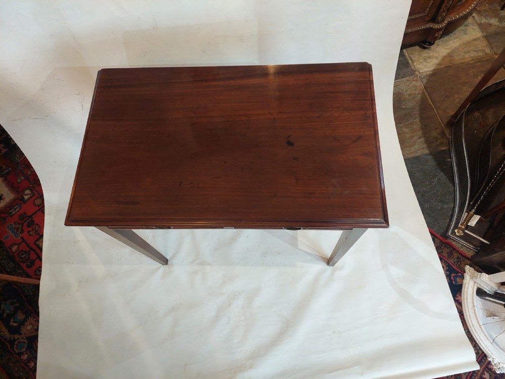 A mid-18th-century Georgian mahogany hall table featuring two drawer fronts with brass swan-neck handles and square tapered legs. View II