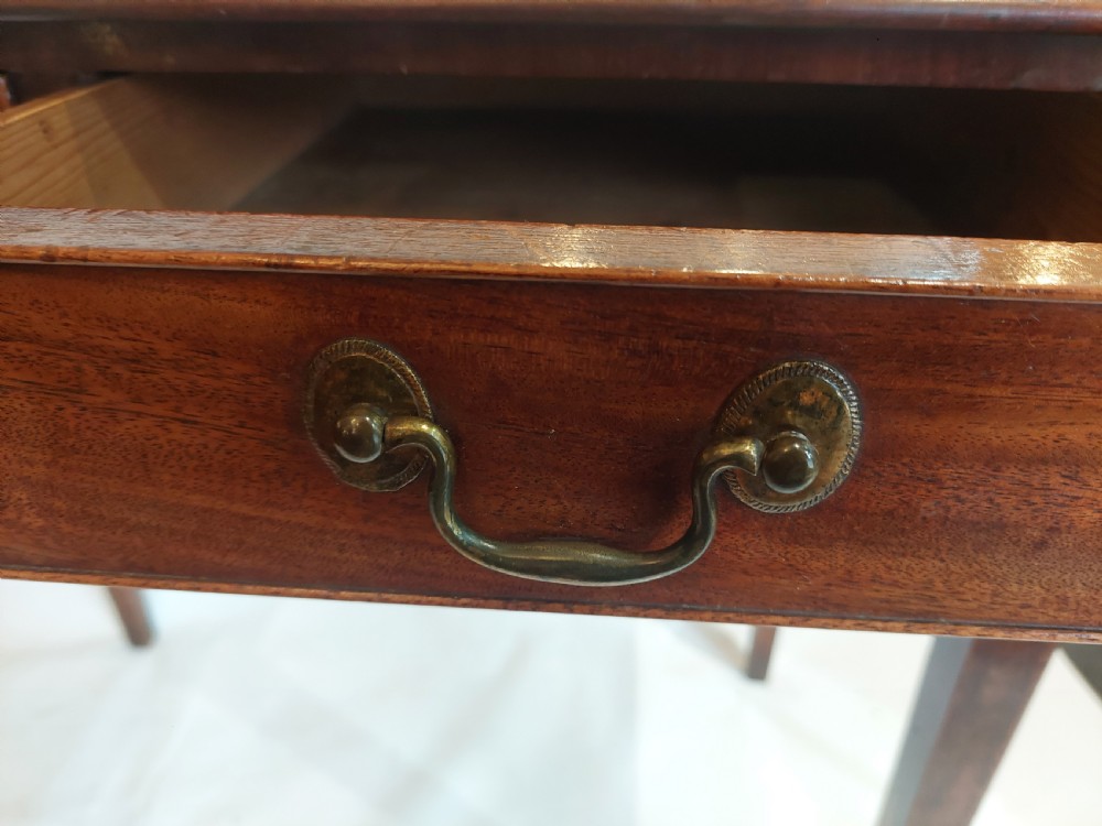A mid-18th-century Georgian mahogany hall table featuring two drawer fronts with brass swan-neck handles and square tapered legs. View V