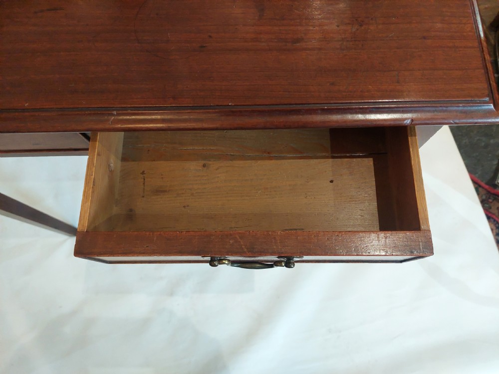 A mid-18th-century Georgian mahogany hall table featuring two drawer fronts with brass swan-neck handles and square tapered legs. View VII