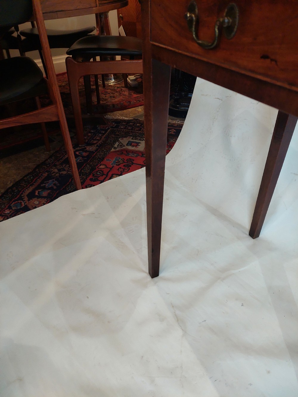 A mid-18th-century Georgian mahogany hall table featuring two drawer fronts with brass swan-neck handles and square tapered legs. View VIII