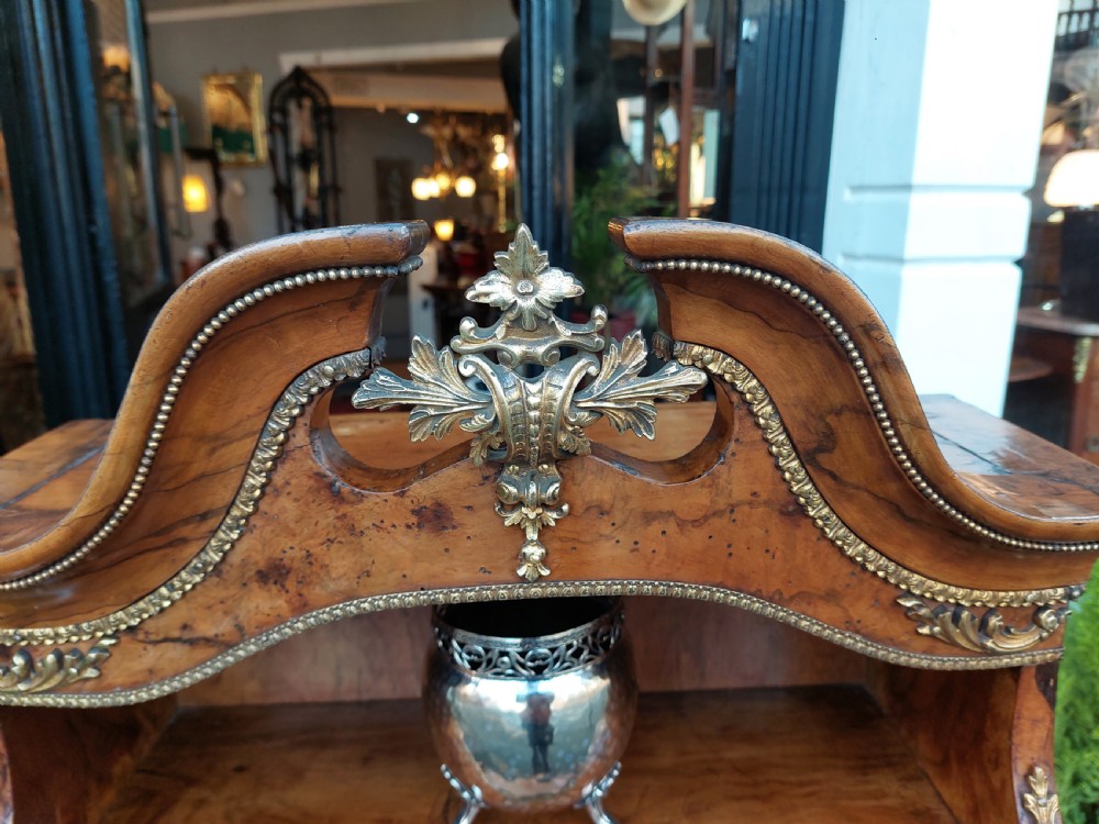 A nineteenth-century French walnut open bookcase featuring serpentine tiers and gilded bronze mounts. View III