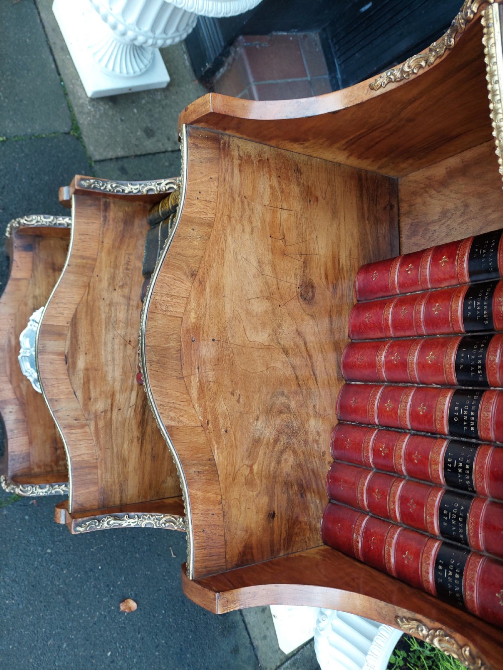 A nineteenth-century French walnut open bookcase featuring serpentine tiers and gilded bronze mounts. View VI